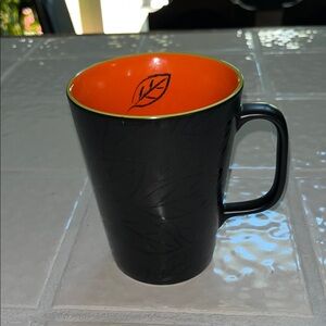 Starbucks Black Mug with Orange Interior and Leaf Accent